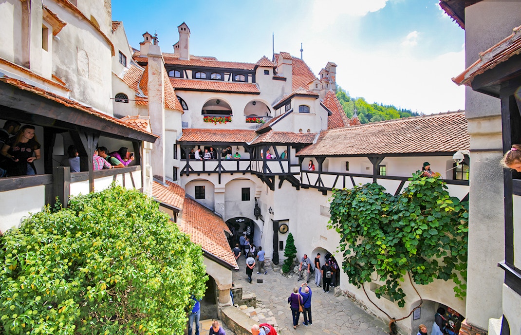 Bran Castle courtyard with stone walls and arched windows, Transylvania, Romania.
