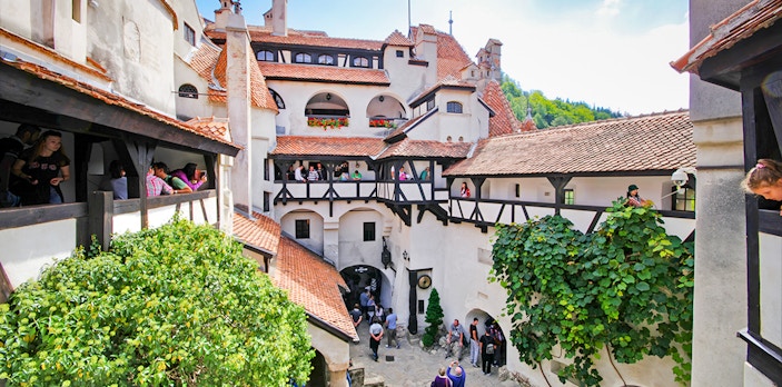 Bran Castle courtyard with stone walls and arched windows, Transylvania, Romania.