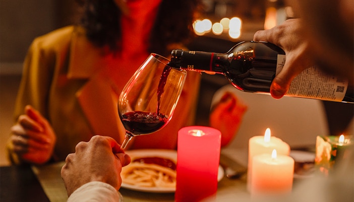 Couple enjoying candlelit dinner with wine