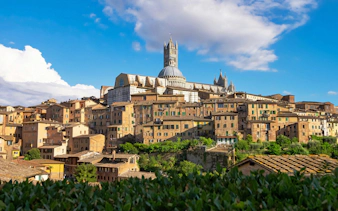 Siena Cathedral rising above the medieval hilltop town of Siena, Tuscany, Italy.