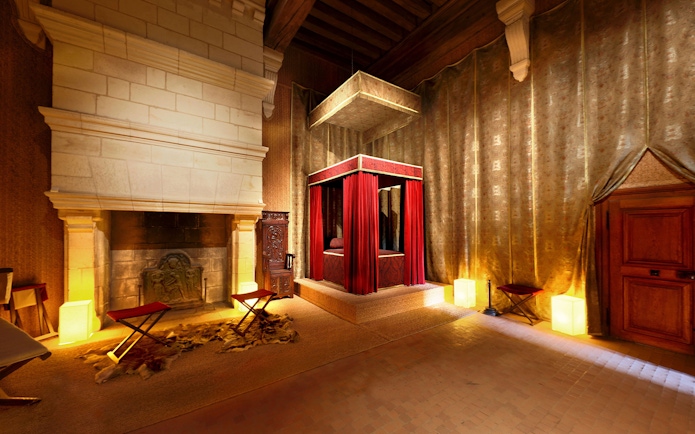 Bedroom of François I with canopy bed and fireplace at Château de Chambord, Loire Valley, France.