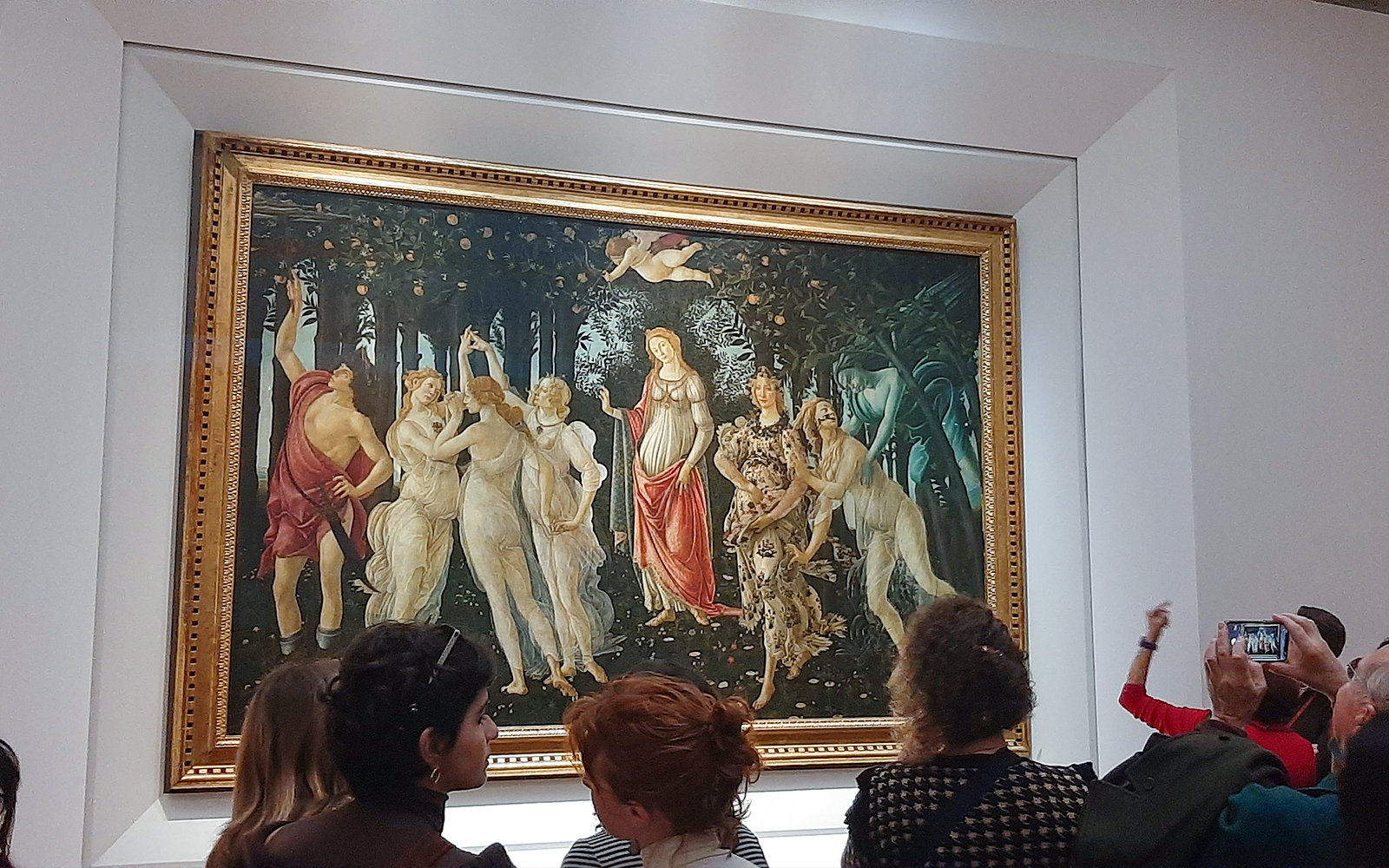 Visitors viewing Botticelli's "Primavera" at the Uffizi Gallery, Florence.