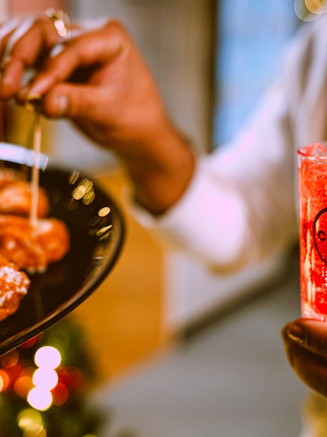 Appetizers and a festive drink on New Year’s Eve Cruise in NYC.