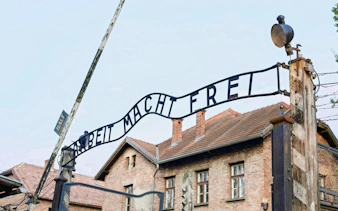 Entrance gate of Auschwitz-Birkenau with "Arbeit Macht Frei" sign, Krakow guided tour.