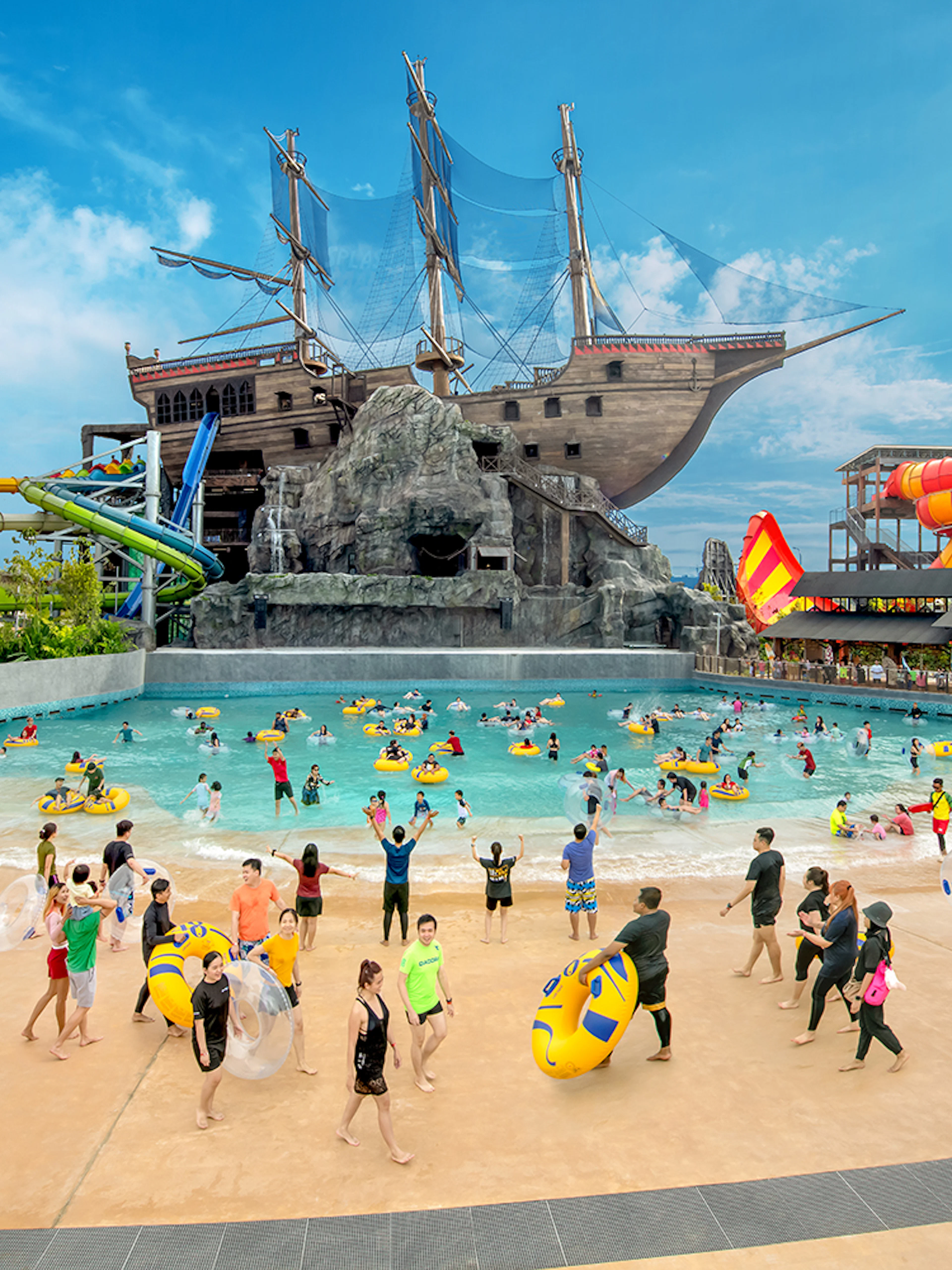 Visitors enjoying the wave pool and slides at SplashMania Waterpark, Gamuda Cove, Selangor.