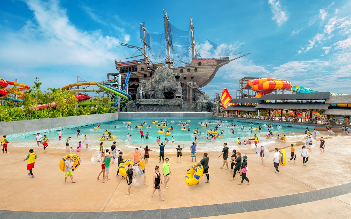 Visitors enjoying the wave pool and slides at SplashMania Waterpark, Gamuda Cove, Selangor.