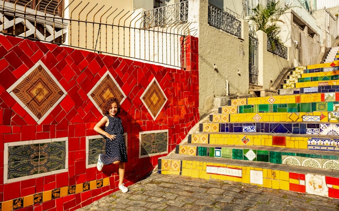Child posing on colorful Selarón Steps in Rio de Janeiro.