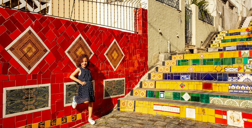 Child posing on colorful Selarón Steps in Rio de Janeiro.