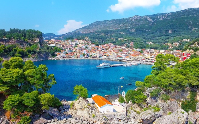 Parga city coastline with colorful buildings and boats in Corfu, Greece.
