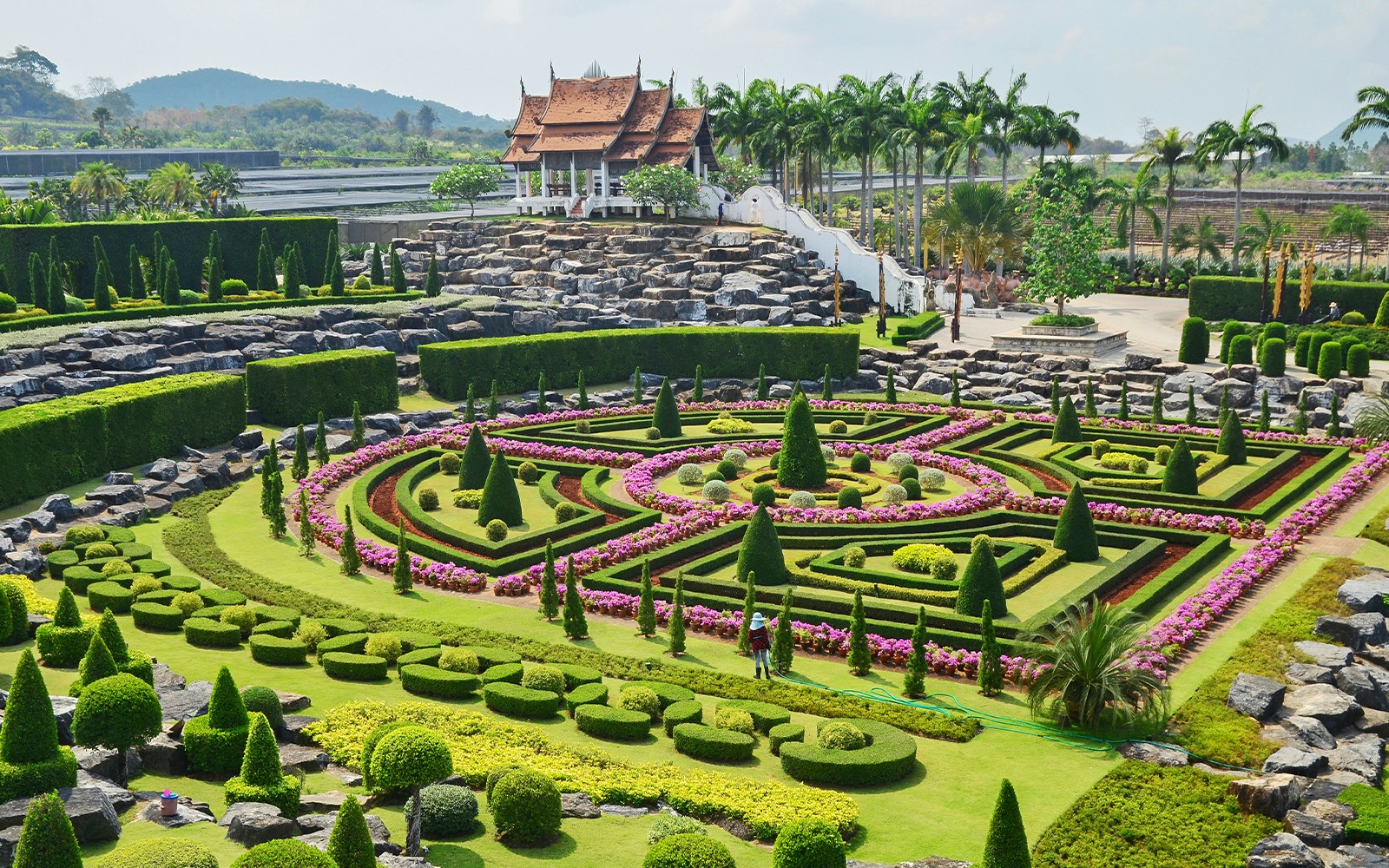 Nong Nooch Tropical Garden Thailand with vibrant floral displays and traditional Thai architecture.