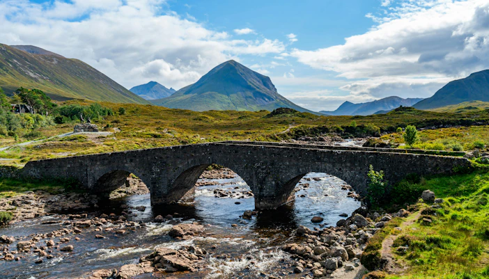 Sligachan Old Bridge over river with mountains in the background, Isle of Skye, Scotland.
