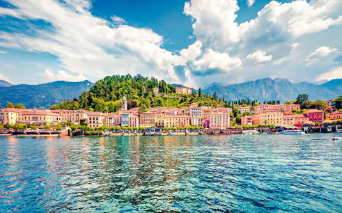 Bellagio waterfront with colorful buildings and mountains, part of Lugano, Bellagio and Cruise Experience from Como.
