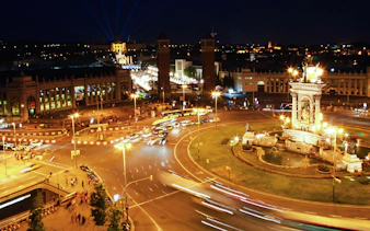Barcelona's Plaça d'Espanya illuminated at night during a city tour.