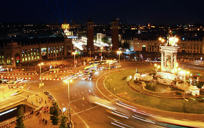 Barcelona's Plaça d'Espanya illuminated at night during a city tour.