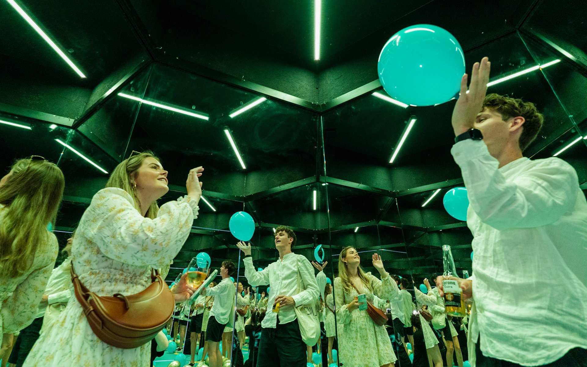 Guests interacting with mirrors and balloons at the Museum of Illusions Amsterdam.