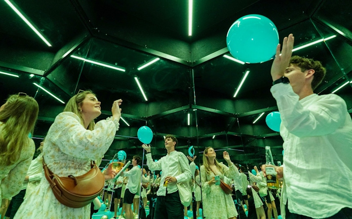 Guests interacting with mirrors and balloons at the Museum of Illusions Amsterdam.