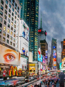 Crowds and bright billboards in Times Square, New York City.