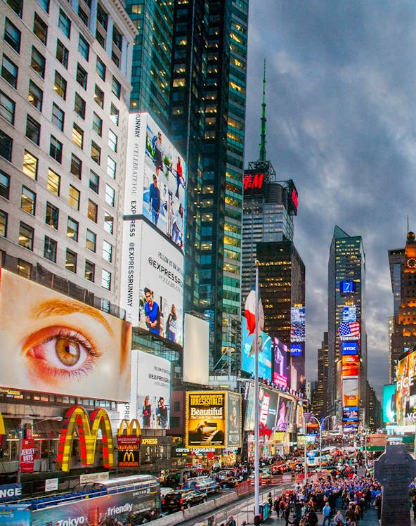 Crowds and bright billboards in Times Square, New York City.