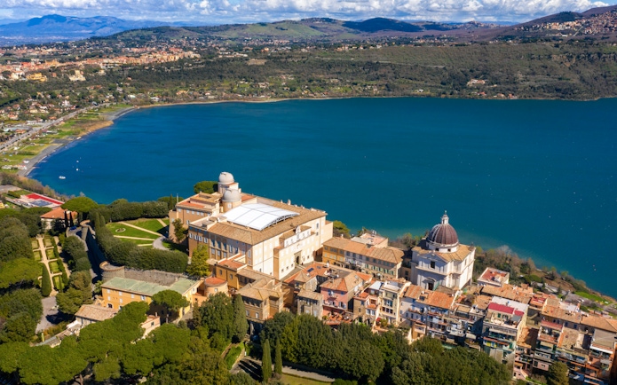 Aerial view of the Papal Palace of Castel Gandolfo overlooking Lake Albano near Rome, Italy.
