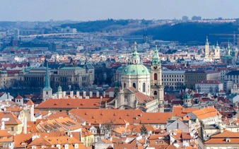 Aerial view of Lesser Town, Prague with St. Nicholas Church and red rooftops.