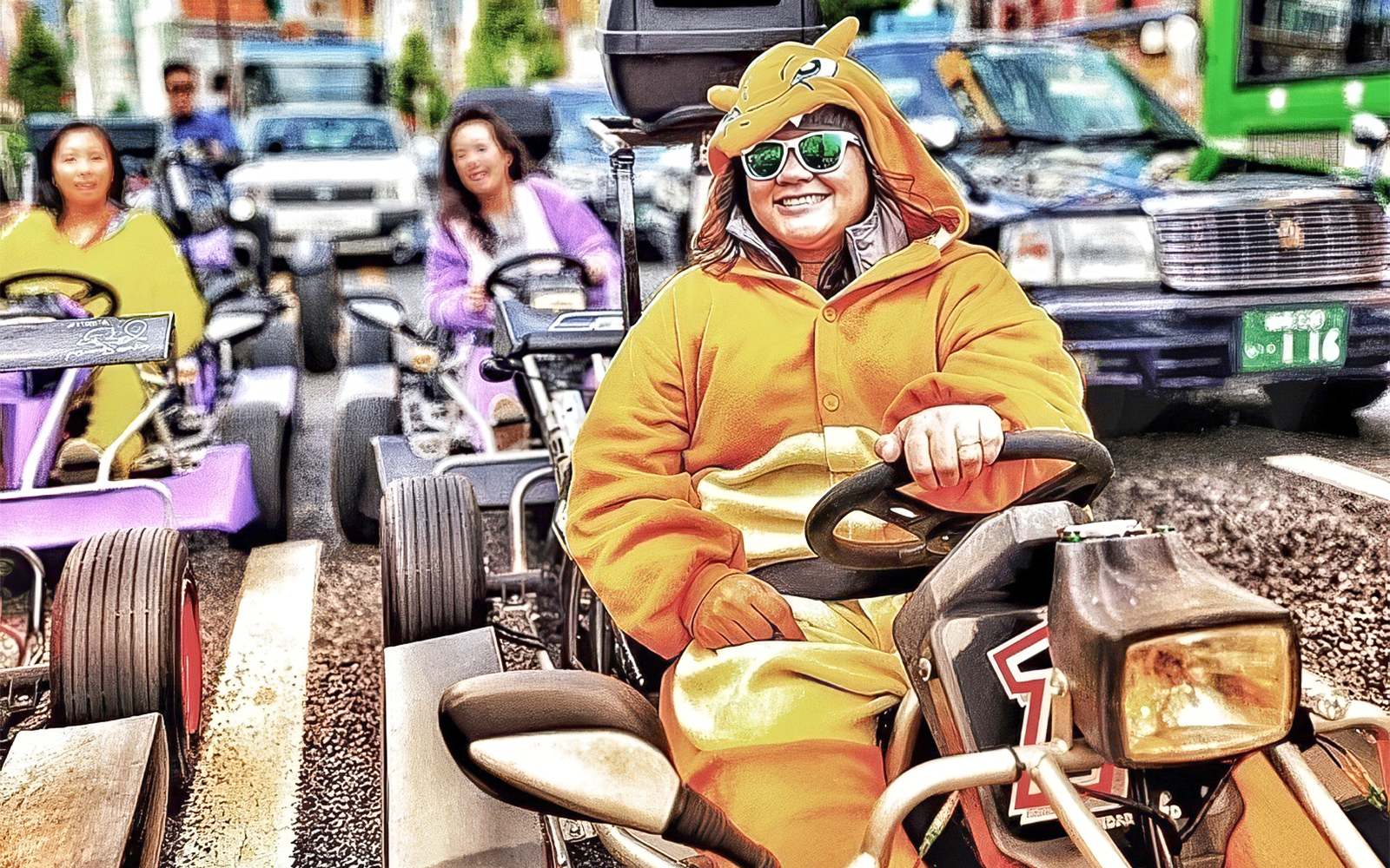 Person in Charmander costume driving a go-kart on a city street.