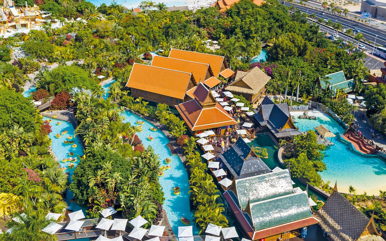 Aerial view of Muai Thai River at Siam Park with lush greenery and traditional architecture.