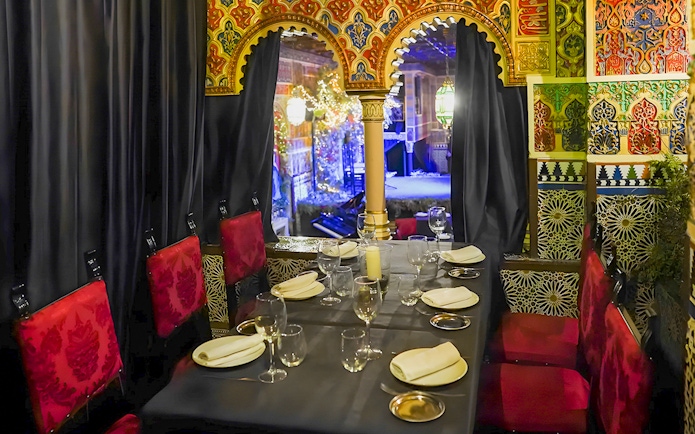 Dining area with ornate decor at Torres Bermejas Flamenco, Madrid.