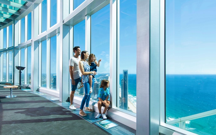 Family obseving skyline and seashore view from SkyPoint Observation Deck