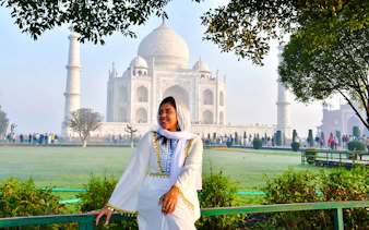 Visitor in traditional attire at the Taj Mahal, Agra, during a private tour from Delhi.