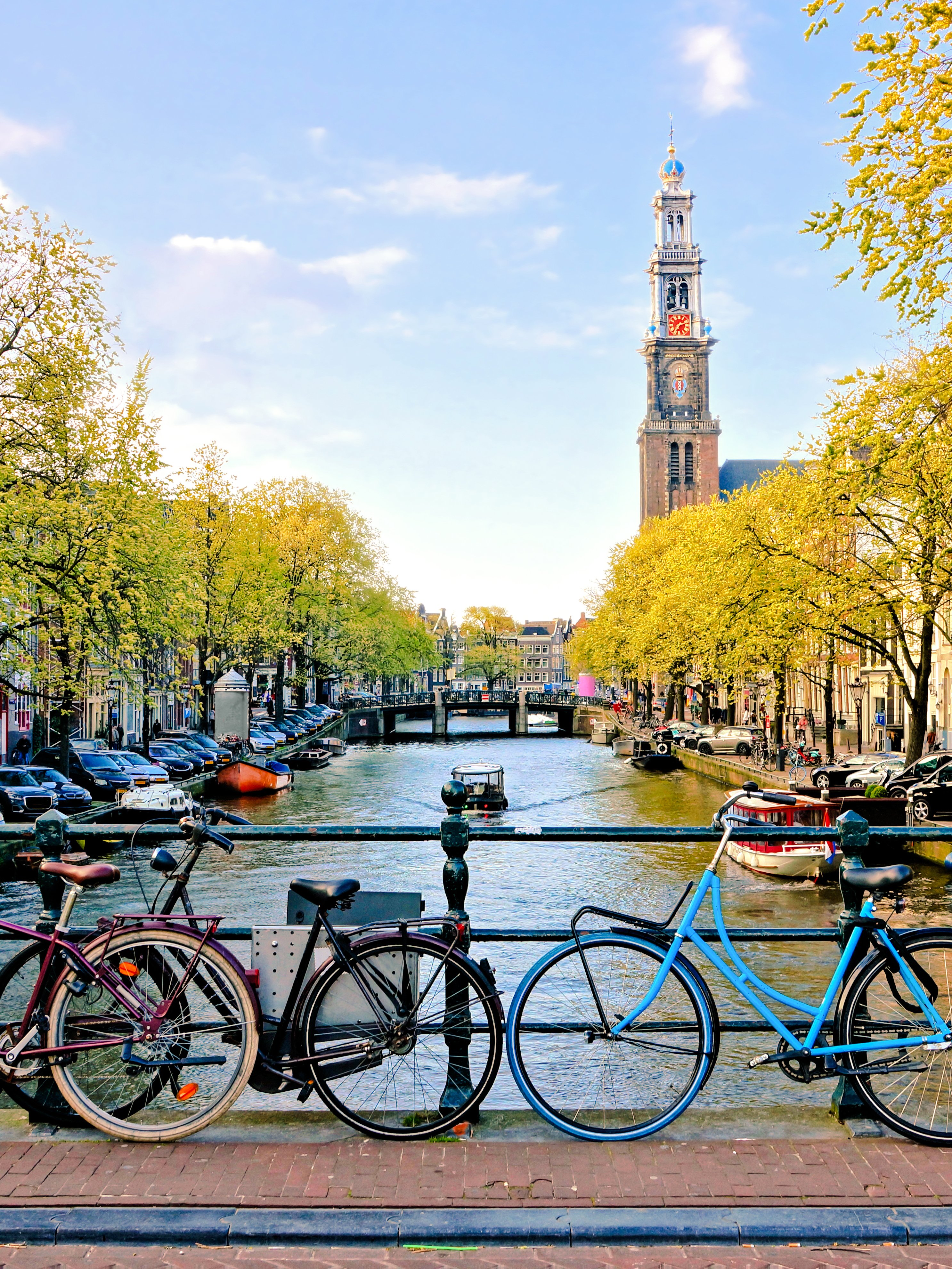 Bicycles parked on a bridge over a canal near Amsterdam Centraal Station.
