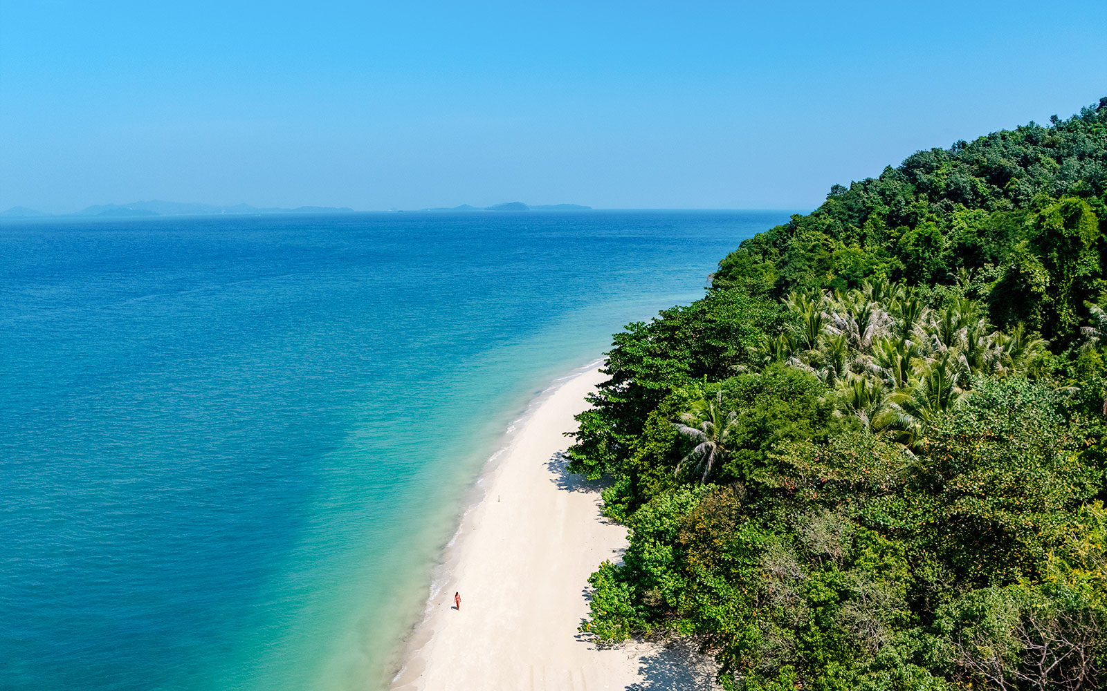 Aerial view of Bamboo Island's white sand beach and clear water, Phuket sunrise tour.