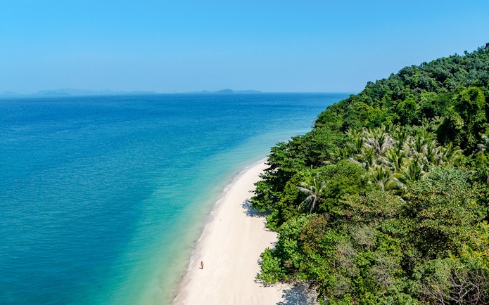 Aerial view of Bamboo Island's white sand beach and clear water, Phuket sunrise tour.