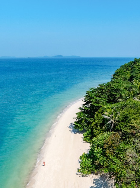 Aerial view of Bamboo Island's white sand beach and clear water, Phuket sunrise tour.
