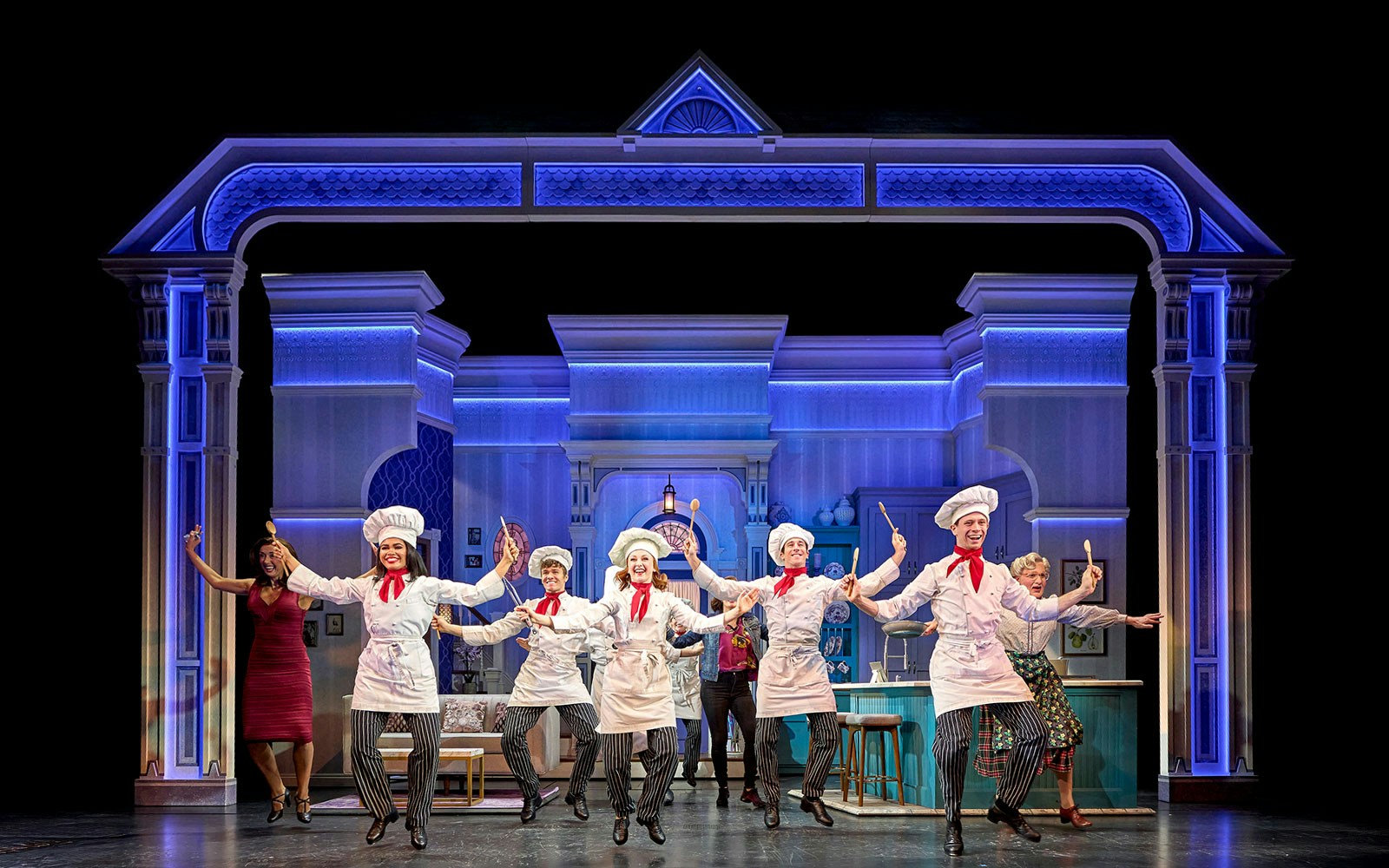 Stage performance of Mrs. Doubtfire musical with actors in chef costumes dancing.