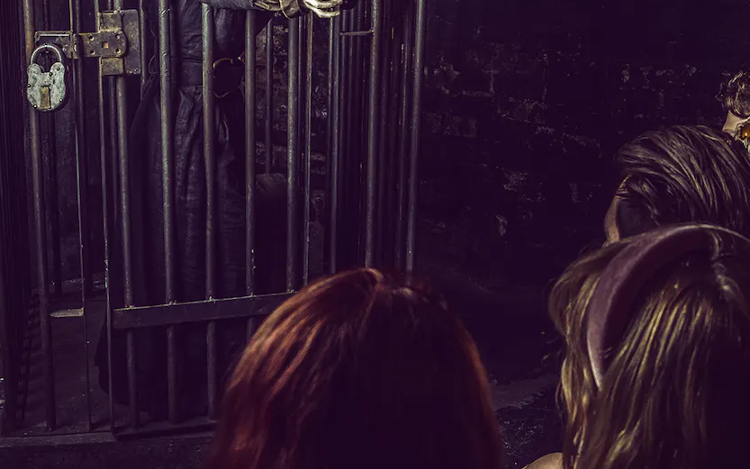 Witch character behind bars at York Dungeon's Curse of the Witch attraction.