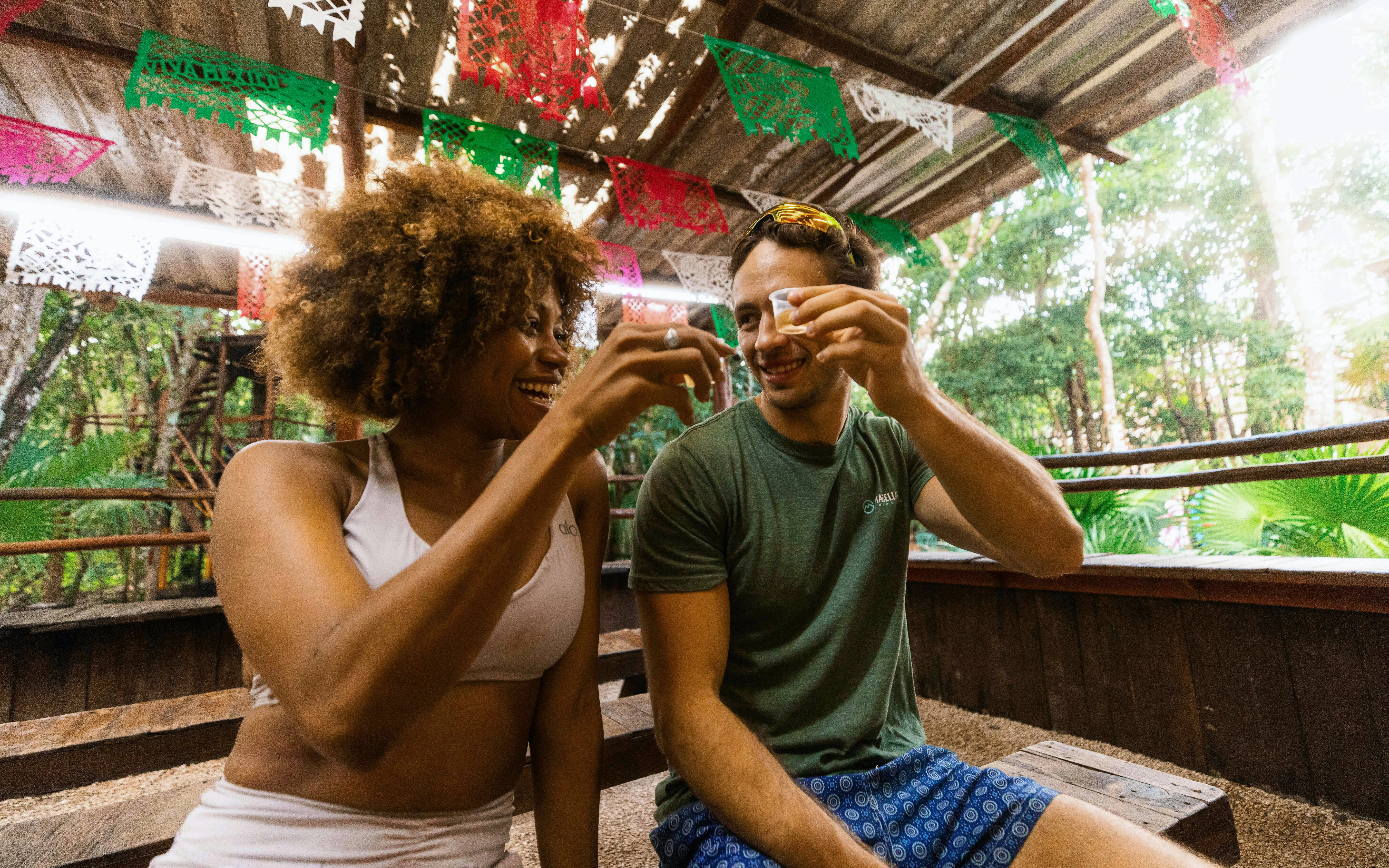Visitors enjoying a toast at Cancun Extreme Adventuring Park under festive decorations.