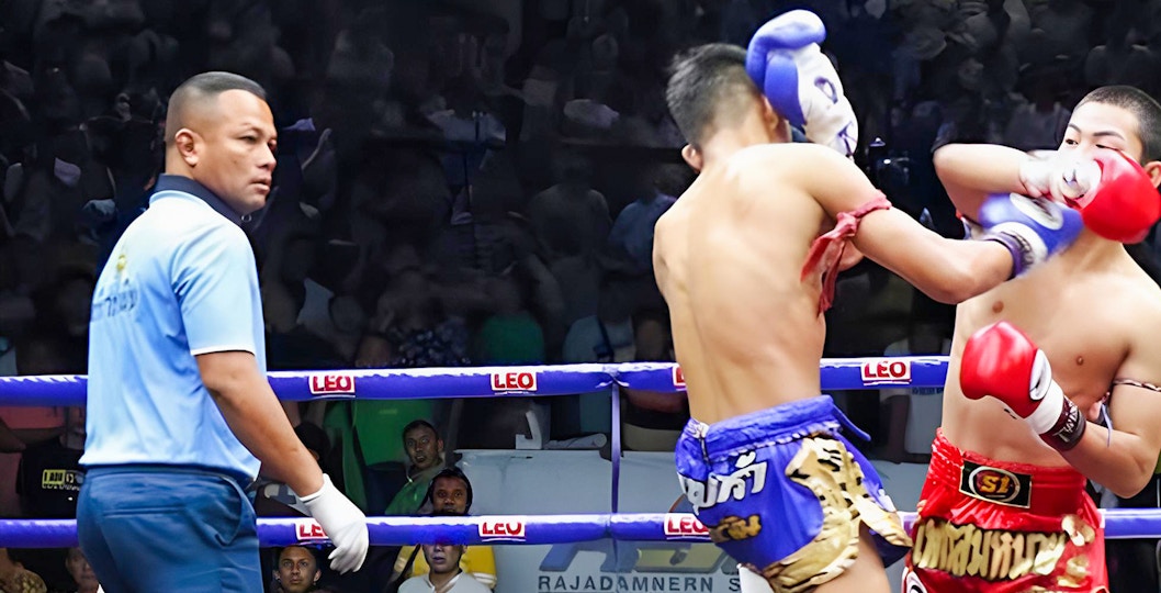 Muay Thai fighters in action at a Bangkok arena.