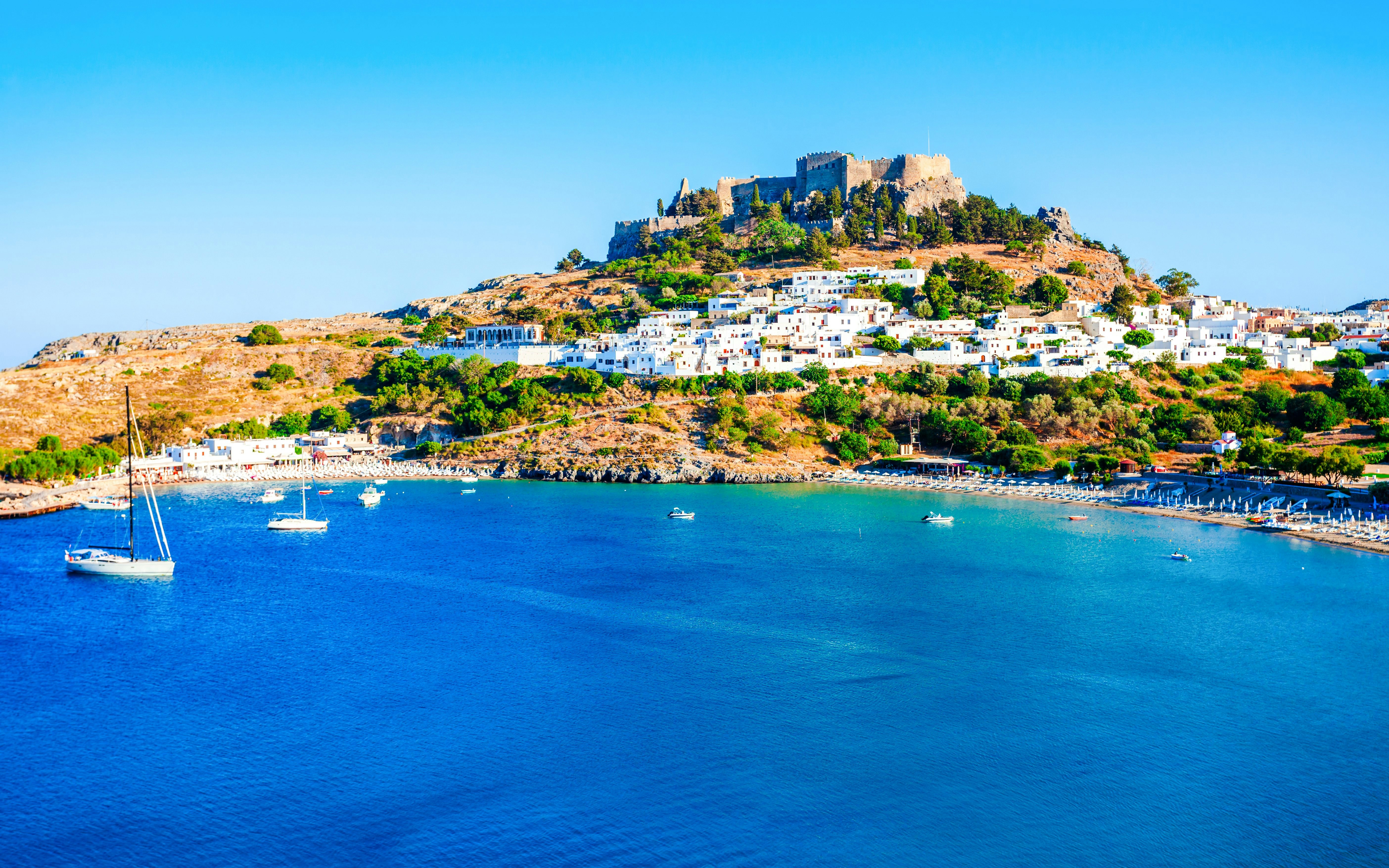 St. Paul’s Bay with Lindos Acropolis in Rhodes, Greece, viewed from a cruise.