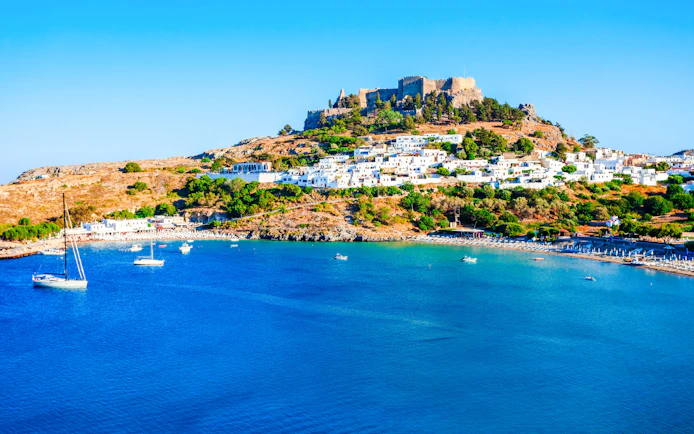 St. Paul’s Bay with Lindos Acropolis in Rhodes, Greece, viewed from a cruise.