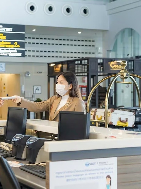 Fast-track service at Donmuang Airport with staff assisting travelers at check-in counter.