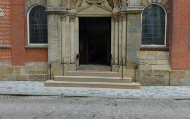 Entrance of historic building with ornate stonework, part of Manchester Secret Society Mystery tour.
