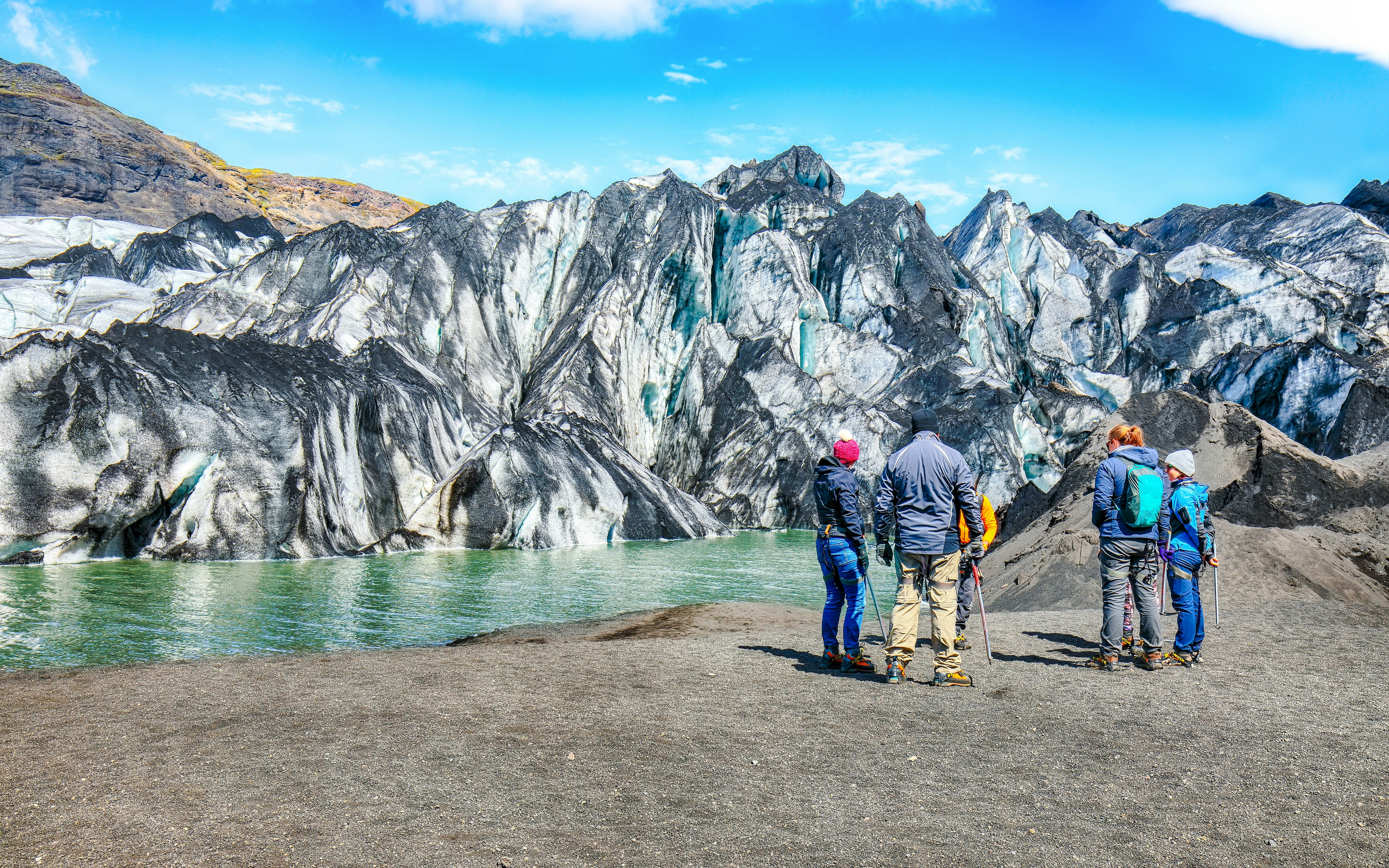 Group of hikers viewing Solheimajokull glacier in Katla Geopark, Iceland.