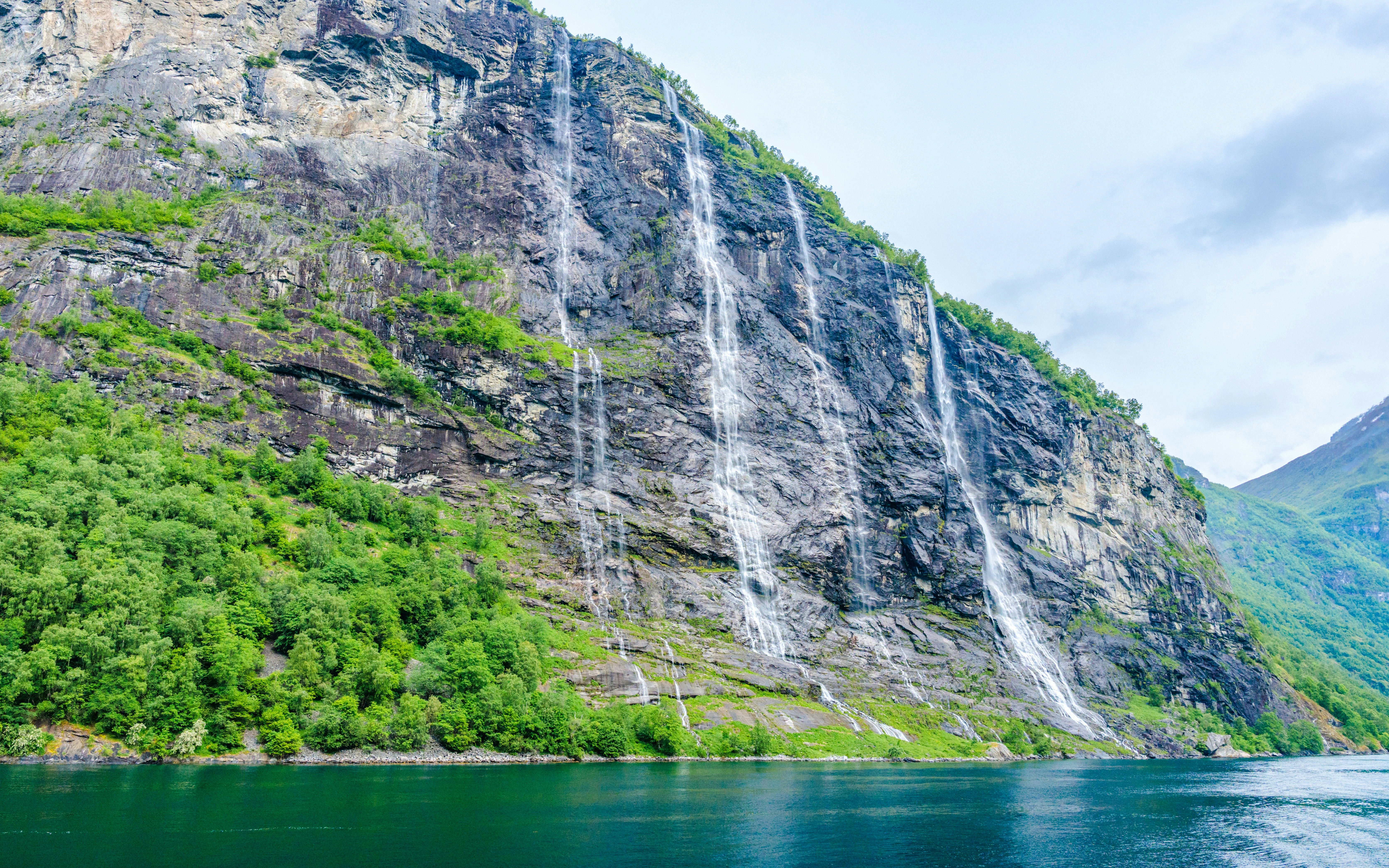 Seven Sisters waterfall cascading down a cliff in Geiranger fjord, Norway.