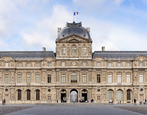 Louvre Museum glass pyramid entrance in Paris, France.