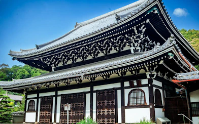Traditional zen temple exterior with ornate roof in Kyoto, Japan.