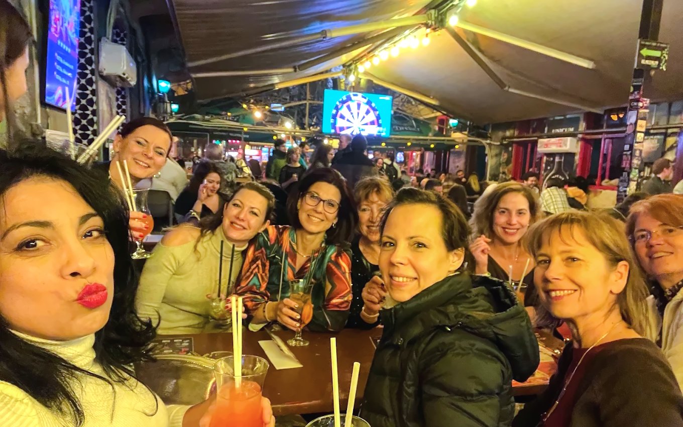 Group enjoying drinks at a lively pub during a bar tour.