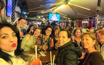 Group enjoying drinks at a lively pub during a bar tour.