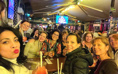 Group enjoying drinks at a lively pub during a bar tour.