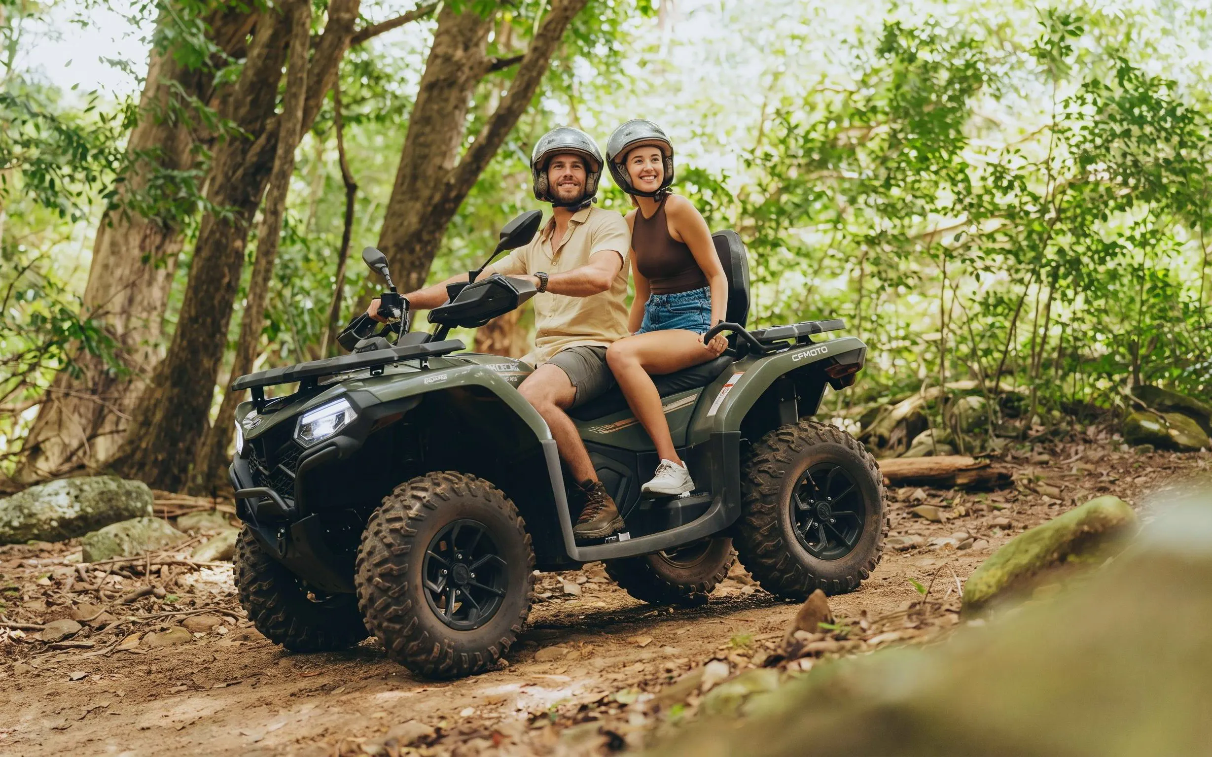 Couple riding quad bike through forest on Bel Ombre tour.