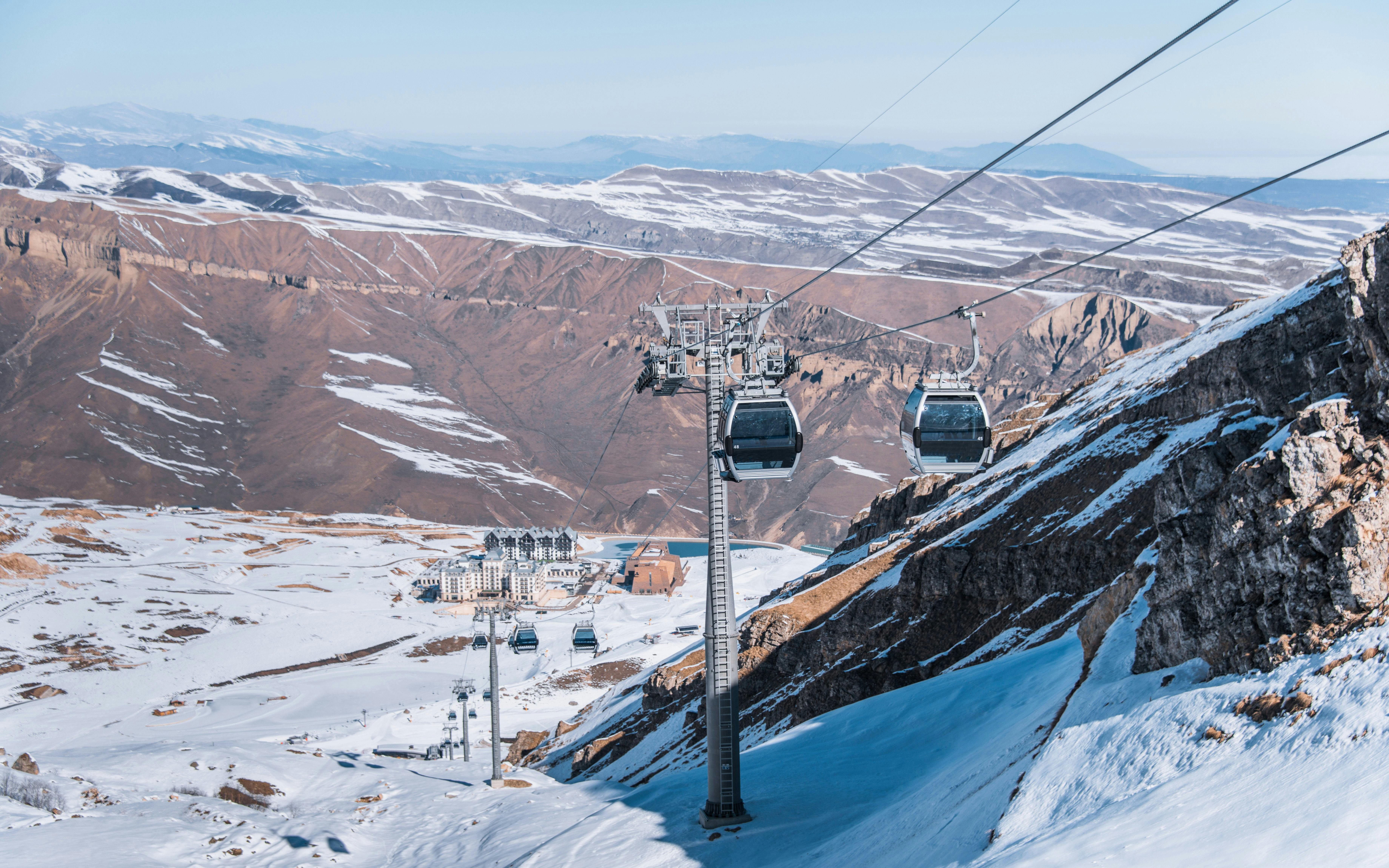 Ski lifts ascending Shahdag mountain resort on a sunny winter day, Baku.